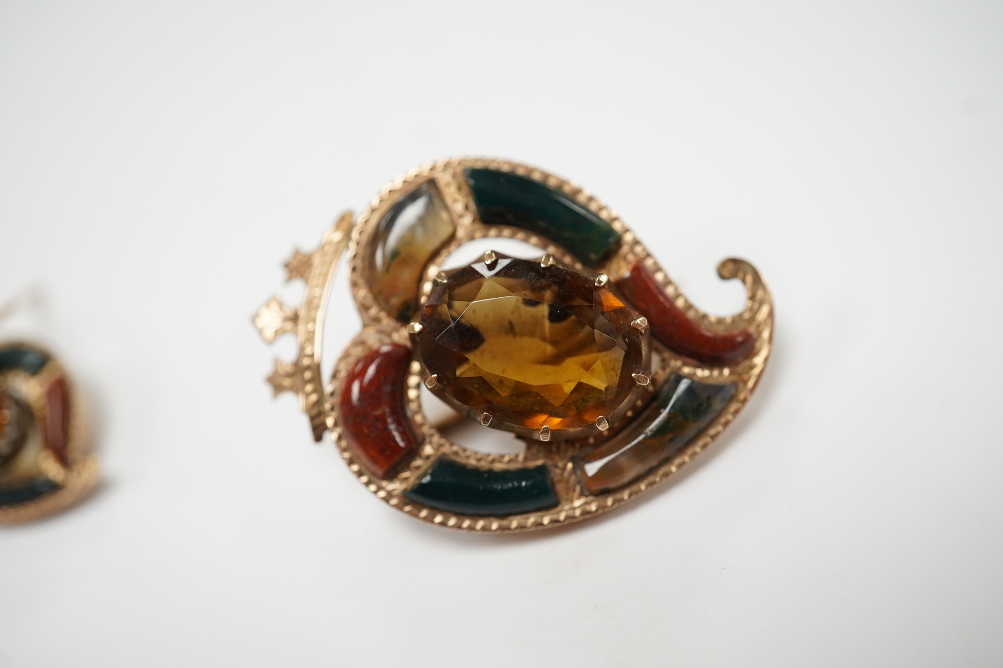 A yellow metal, Scottish hardstone and citrine set suite of jewellery, comprising a brooch, 30mm and pair of earrings, gross weight 7 grams. Condition - fair